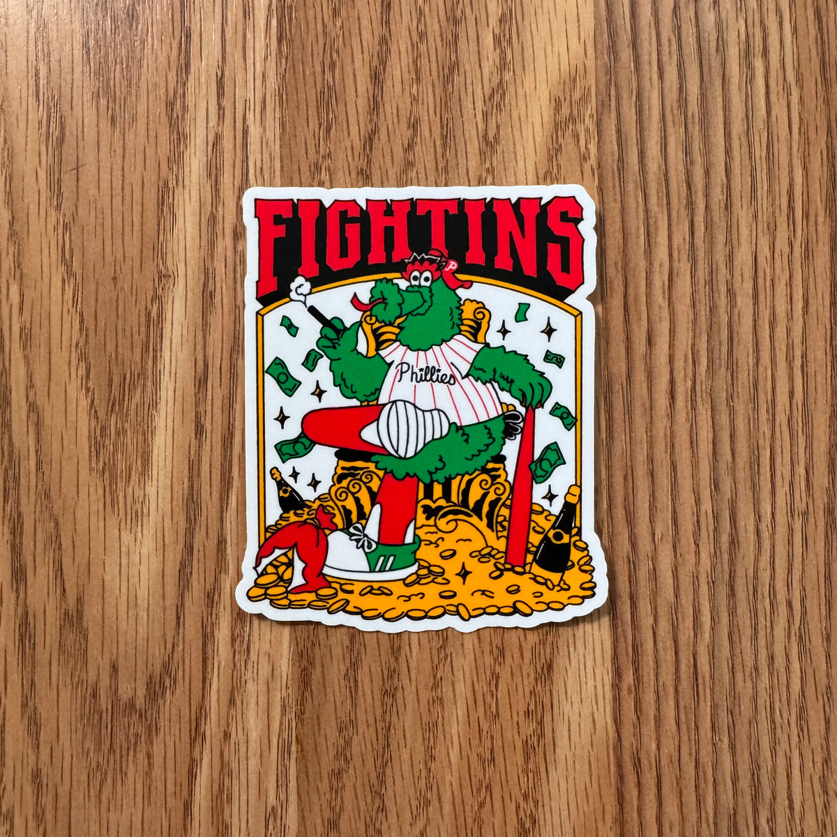 Sticker with a cartoon character and 'FIGHTINS' text on a wooden surface