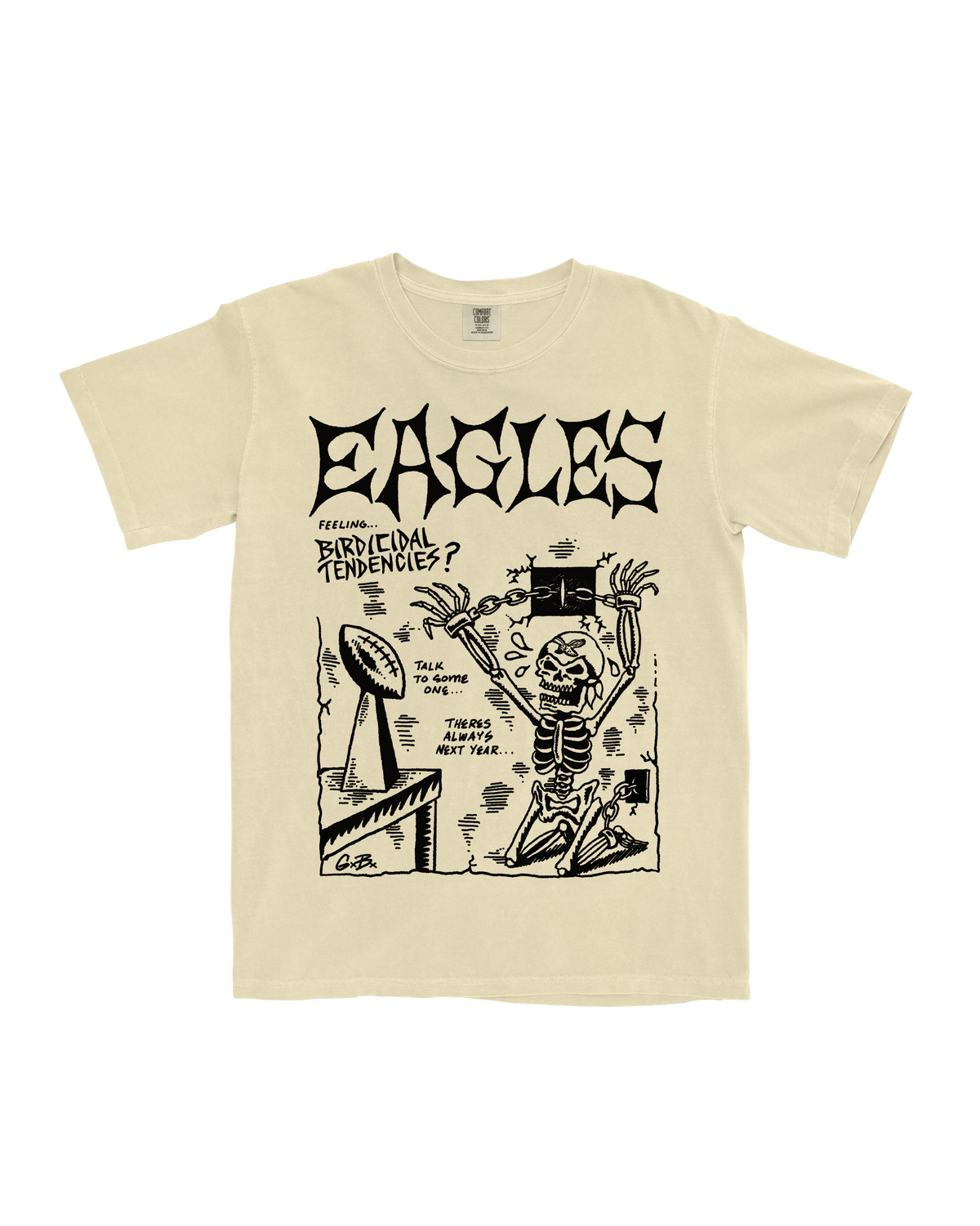 Beige t-shirt with black graphic design featuring a skeleton and text on a white background