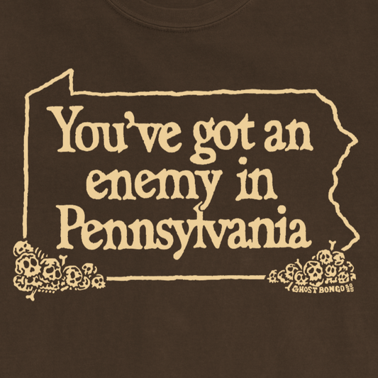Brown t-shirt with yellow text and graphics on a white background
