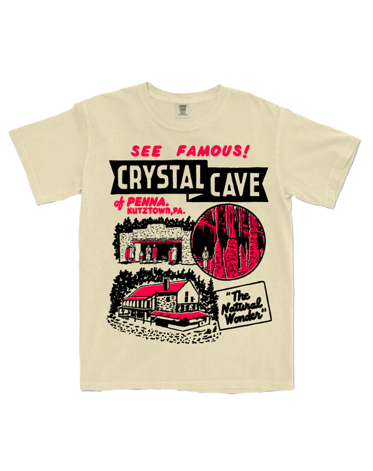 Beige t-shirt with 'Crystal Cave' graphic design on a white background