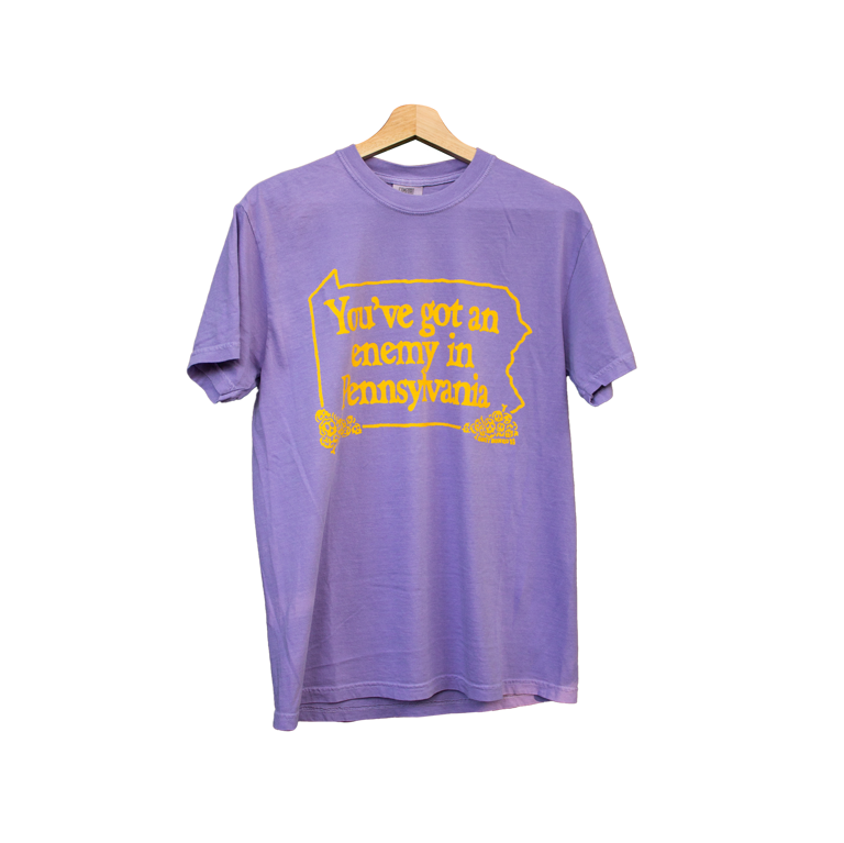 Purple t-shirt with yellow text on a white background