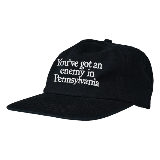 Black cap with white text 'You've got an enemy in Pennsylvania' on a transparent background