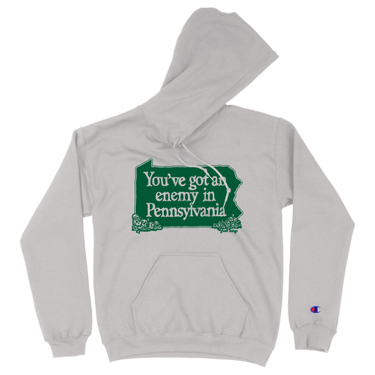 Gray hoodie with green graphic and text 'You've got an enemy in Pennsylvania' on a white background