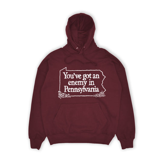 Maroon hoodie with white text 'You've got an enemy in Pennsylvania' on a white background