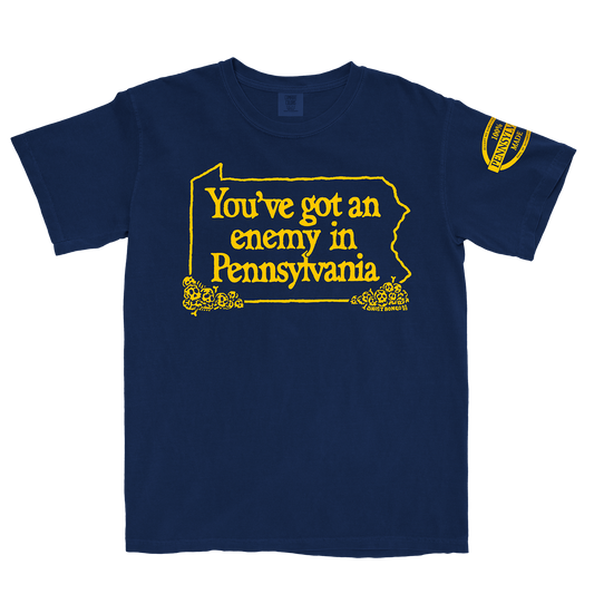 Navy blue t-shirt with yellow text "You've got an enemy in Pennsylvania" and design on a white background