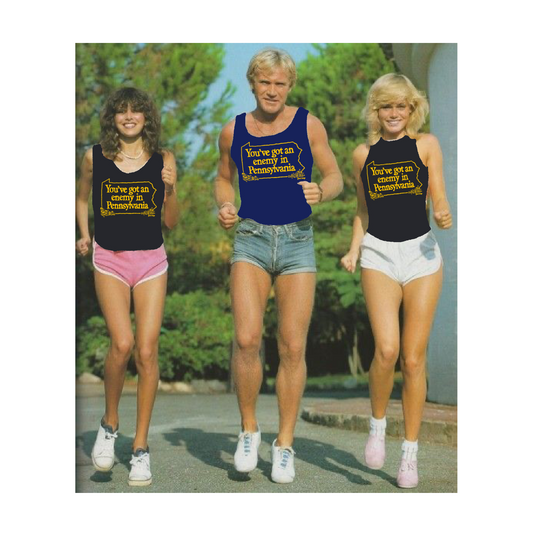 Three people in vintage running gear with text 'You've got an enemy in Pennsylvania' on their shirts outdoors.