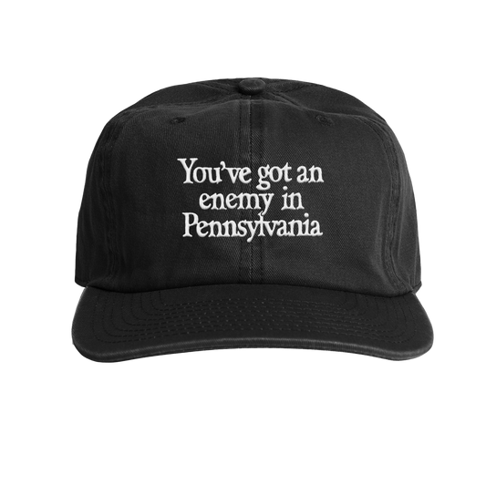 Black cap with white text 'You've got an enemy in Pennsylvania' on a transparent background