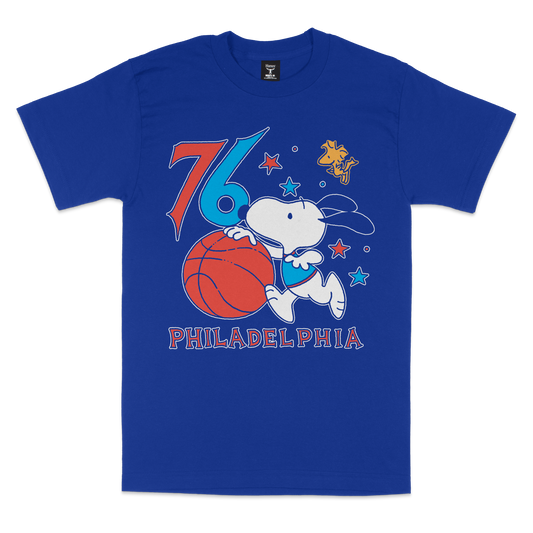 Blue t-shirt with a graphic of a dog holding a basketball and the number '76' on a white background