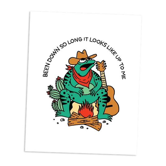Cartoon frog in a cowboy hat playing guitar by a campfire with text on a white background